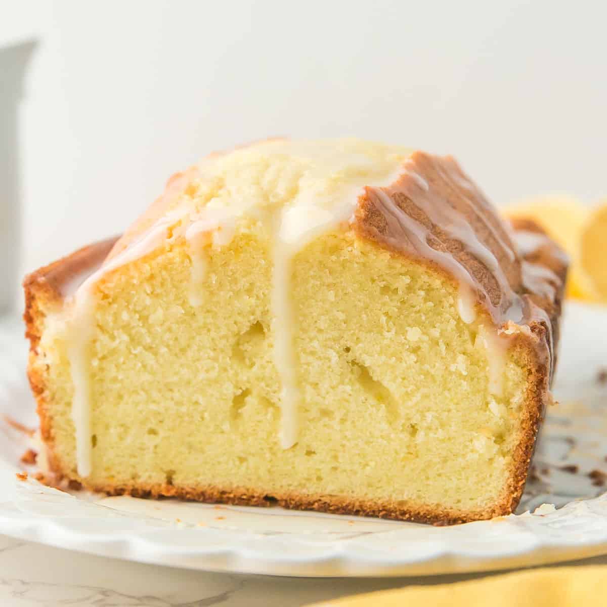 A lemon loaf cake on a white plate.