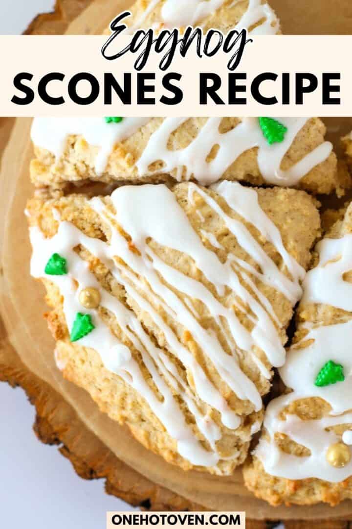 Eggnog scones topped with white icing and small green holiday decorations, arranged on a wooden platter. Text overlay reads "Eggnog Scones Recipe.