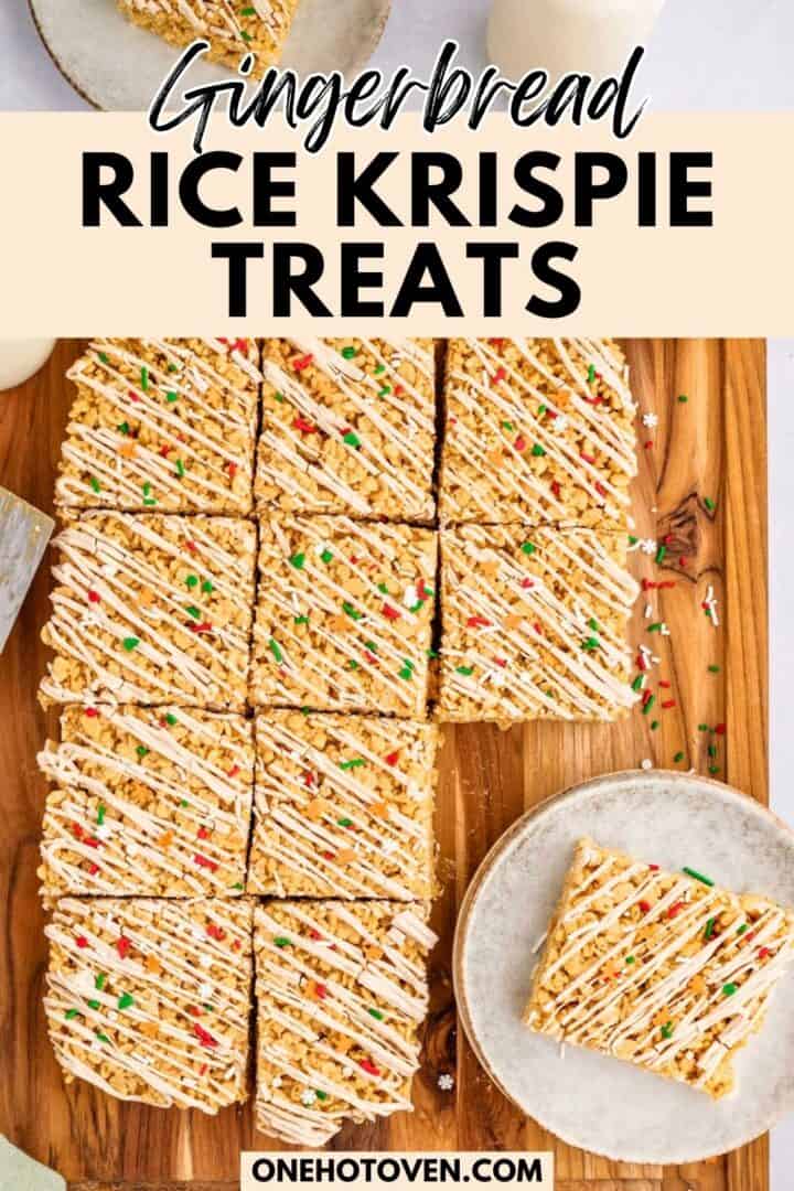 A wooden board with gingerbread Rice Krispie treats cut into squares, drizzled with white icing and topped with sprinkles; one treat is on a separate plate.