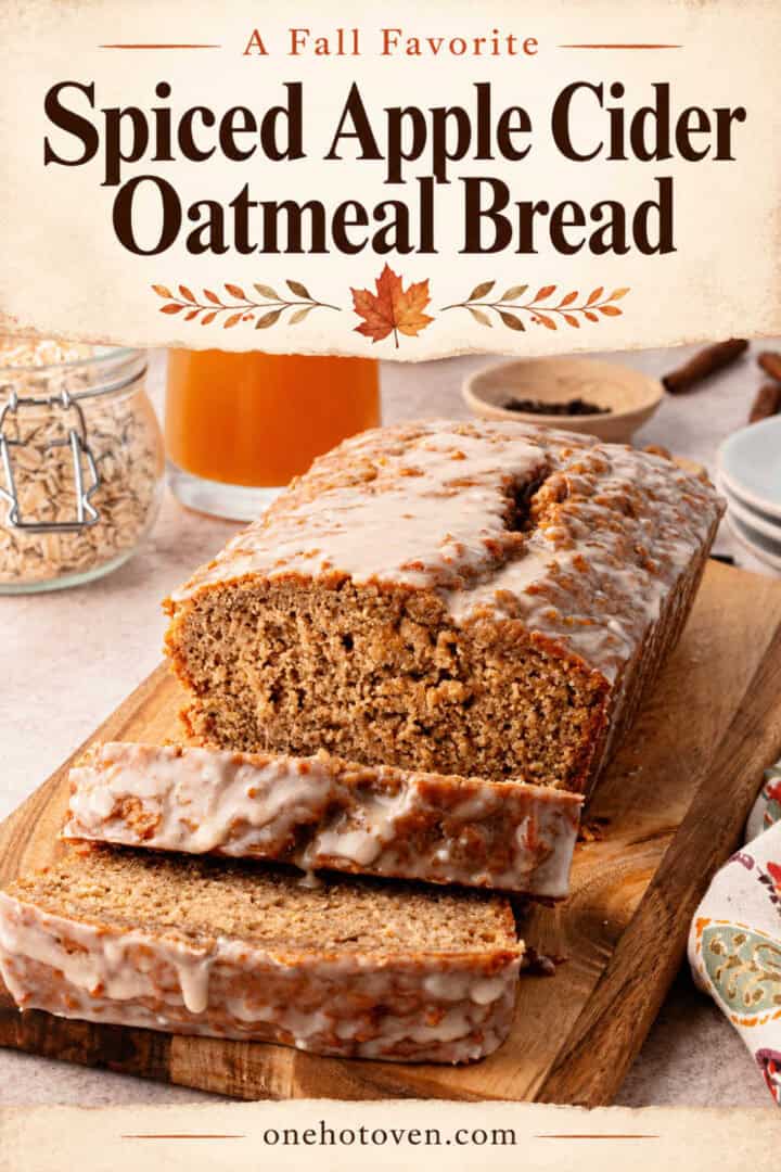 A loaf of glazed spiced apple cider oatmeal bread on a wooden cutting board with two slices cut, below the text “A Fall Favorite Spiced Apple Cider Oatmeal Bread.”
